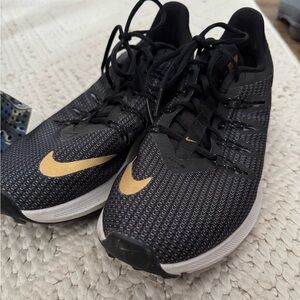 Comfy gold and black Nike shoes
